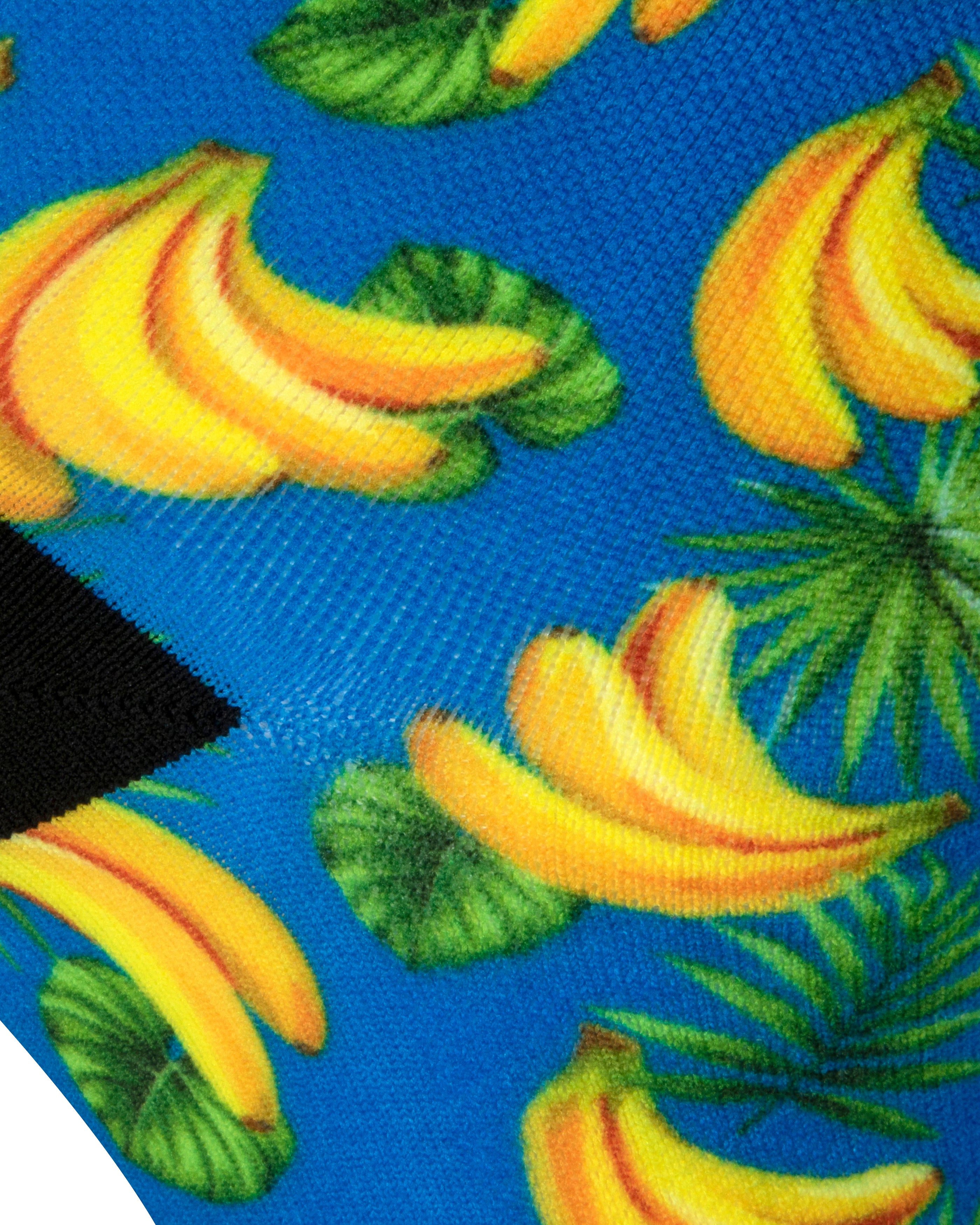 Textured heel view of a blue seamless toe sock with a vibrant yellow banana print design and black heel.