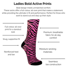 Pink and black zebra-striped sock with technical product features on a white background.