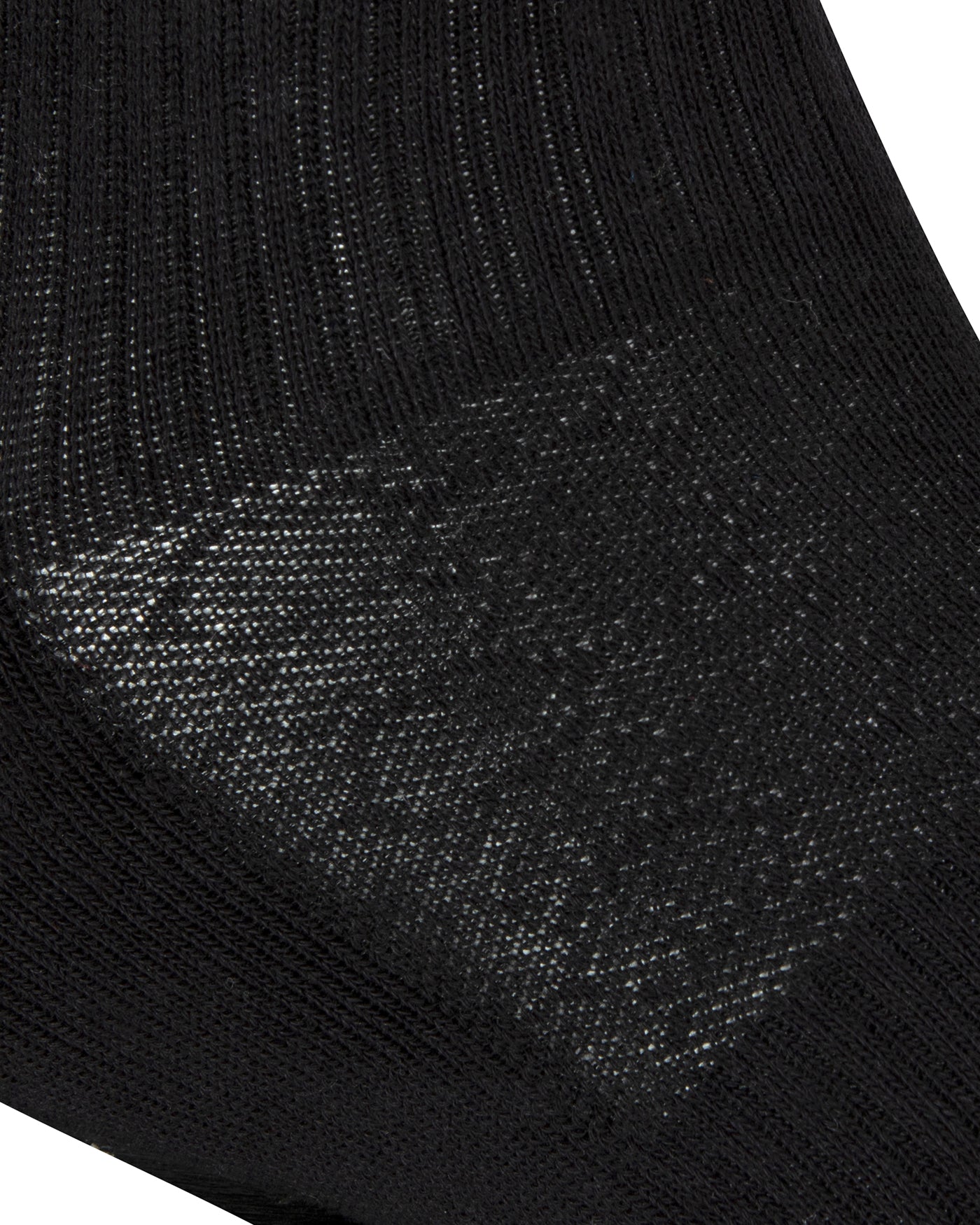 Textured view of a long length ribbed black combed cotton seamless toe anklet with cushioned foot and circular gripper around the arch of the foot.