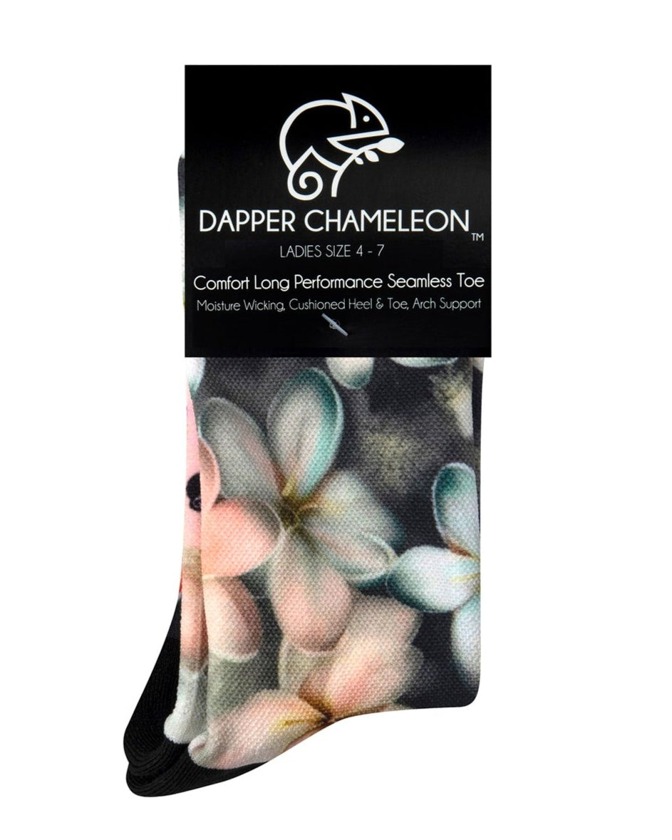 Header card packaging of a dark grey seamless toe sock with pastel hues of white, cream, yellow, and light pink frangipani print design and black heel and toe.