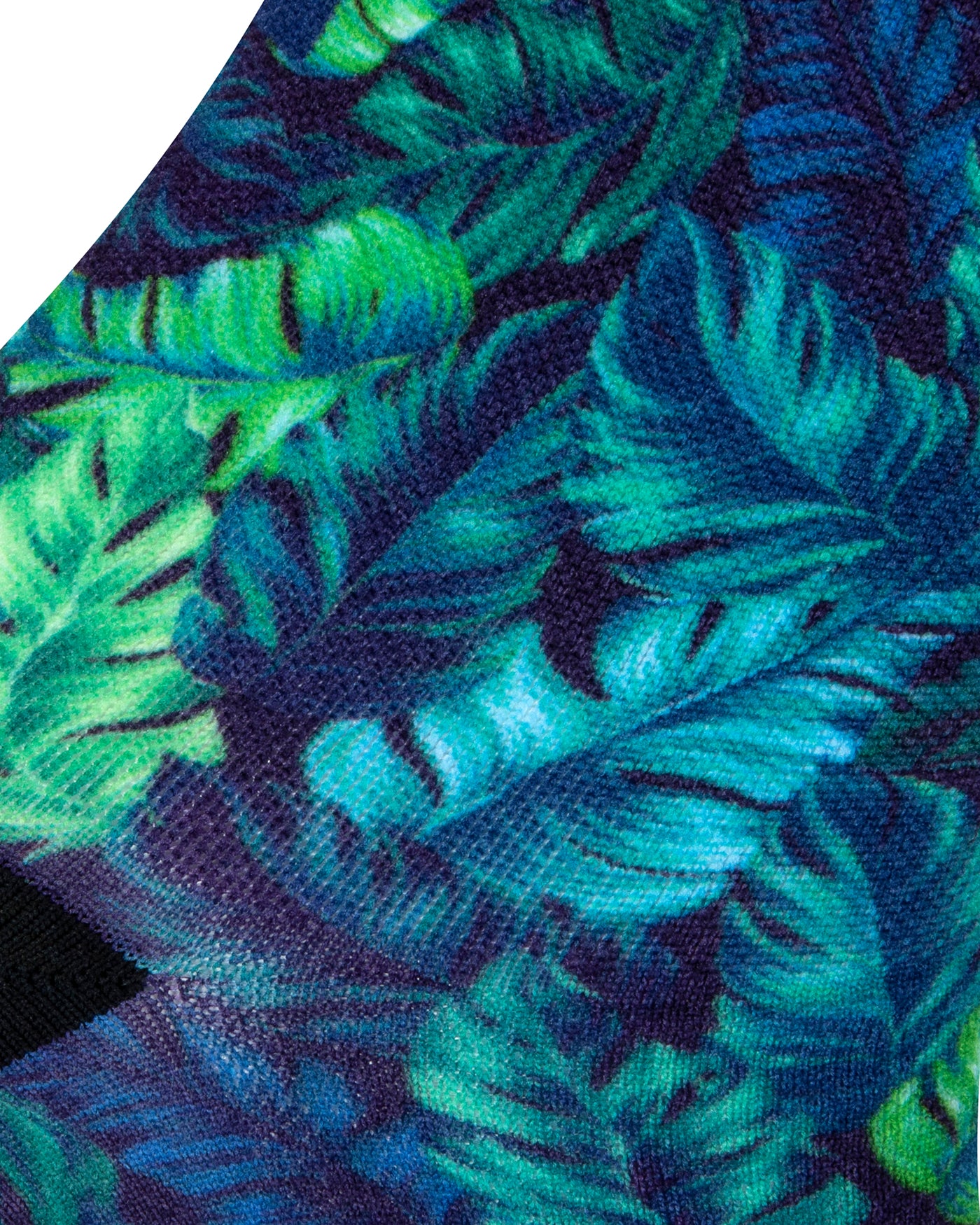 Textured heel view of a blue seamless toe sock with green and blue topical fern design print and black heel.