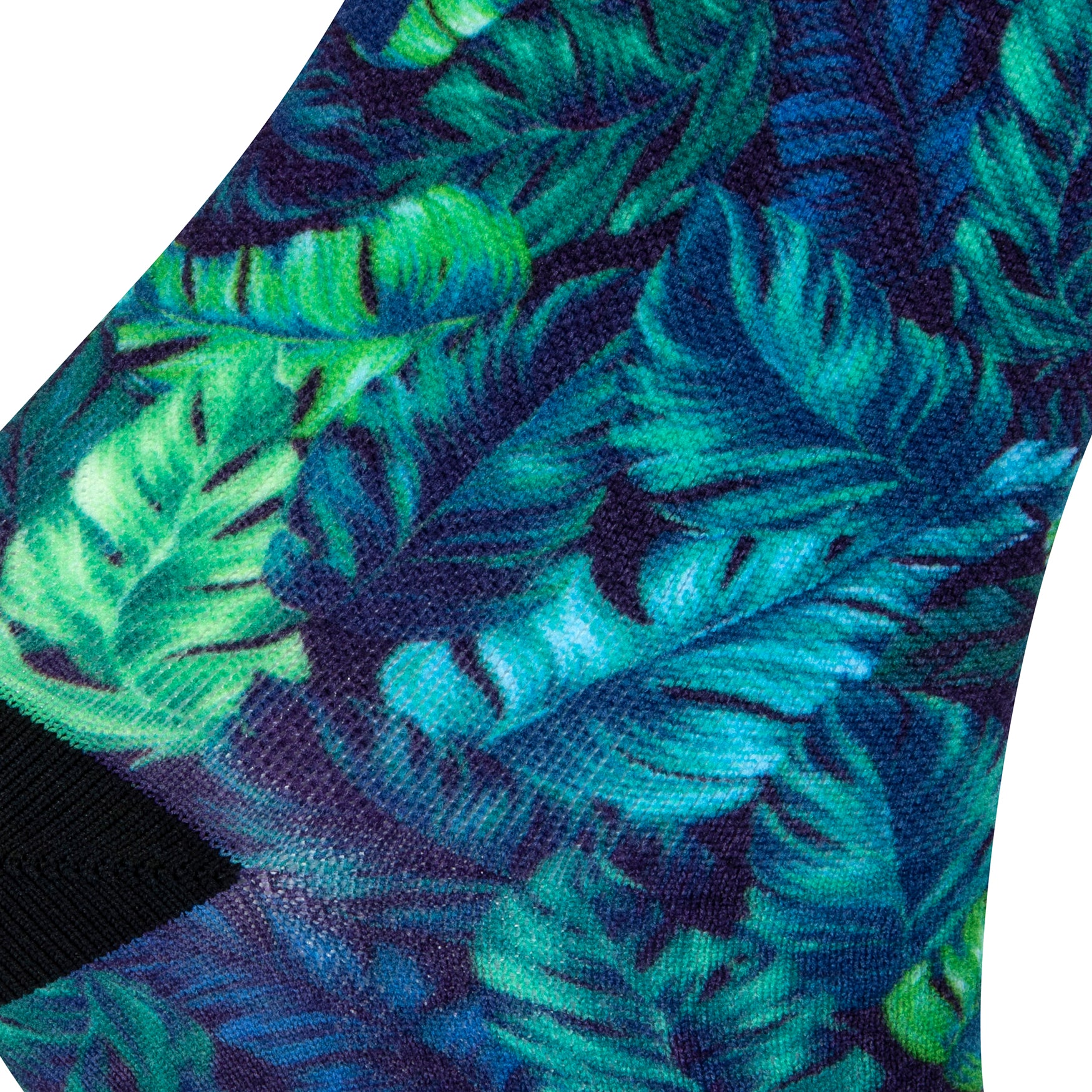 Textured heel view of a blue seamless toe sock with green and blue topical fern design print and black heel.