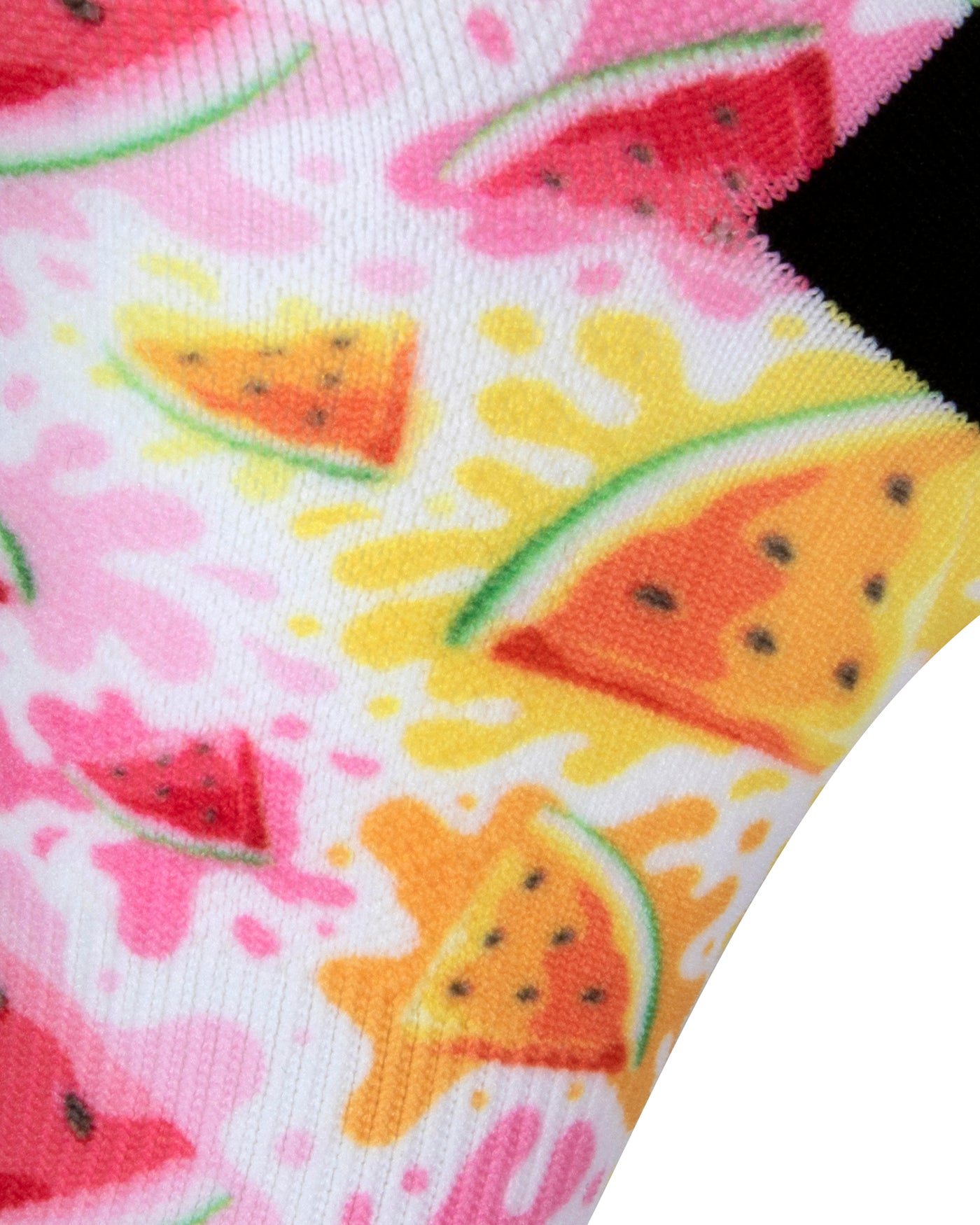 Textured heel view of a white seamless toe sock with pink and orange watermelon slices and pink, yellow and orange paint splashes design print and black heel.
