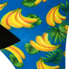 Textured heel view of a blue seamless toe sock with a vibrant yellow banana print design and black heel.