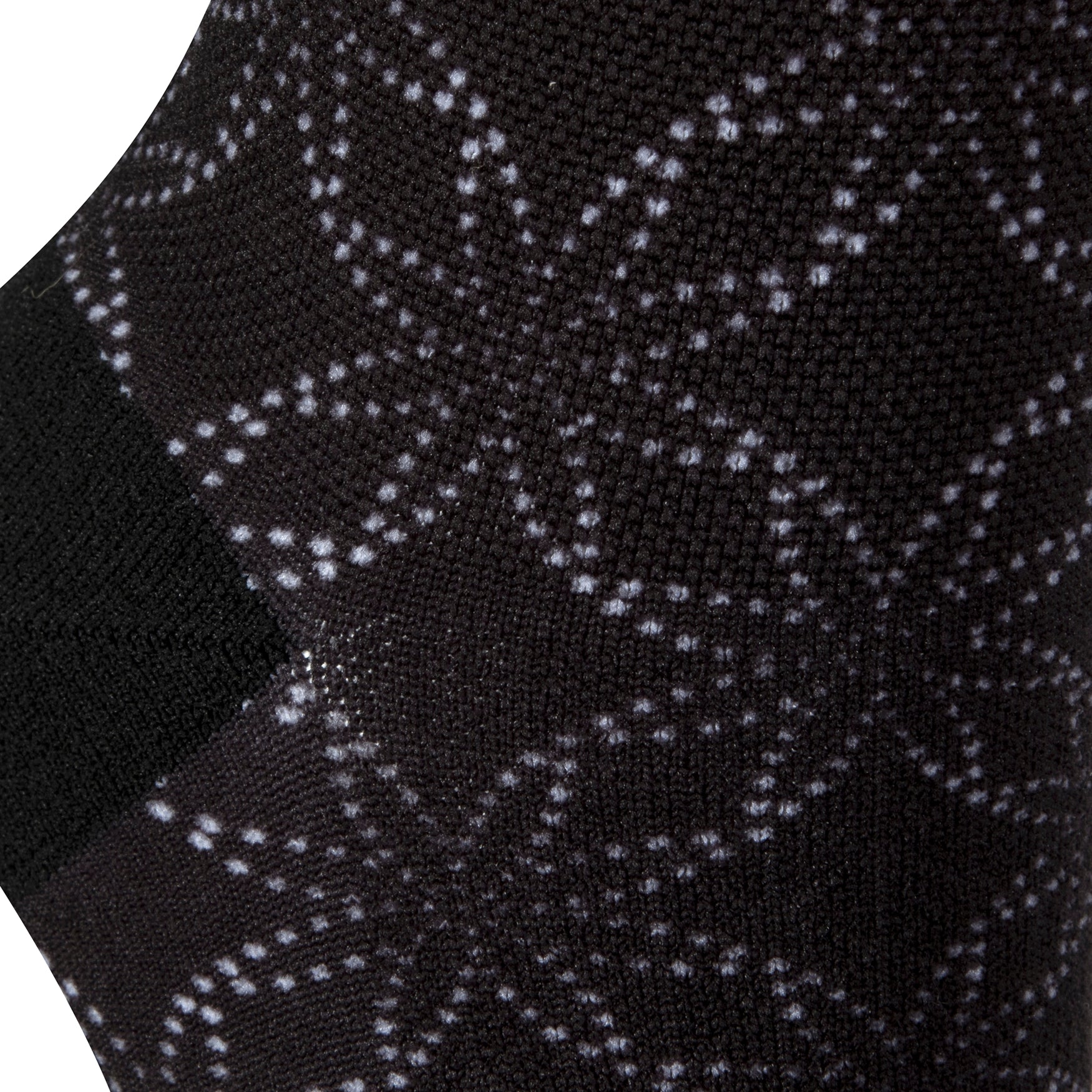 Textured heel view of black seamless toe sock with floral white dot print design and black heel.