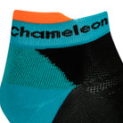 Side view of a black seamless toe sport sock with teal green cushioned heel and bright orange lip and black Dapper Chameleon wording on the cuff.