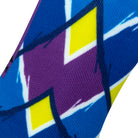 Textured view of blue seamless toe sock with blue, purple and yellow geometric print design.