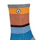 Side view of a long length ribbed grey combed cotton seamless toe anklet with yellow, orange, black, white, royal and sky blue stripes with Dapper Chameleon logo.