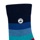 Side view of a combed cotton dark blue seamless toe anklet with blue, red and maroon stripes and Dapper Chameleon logo.