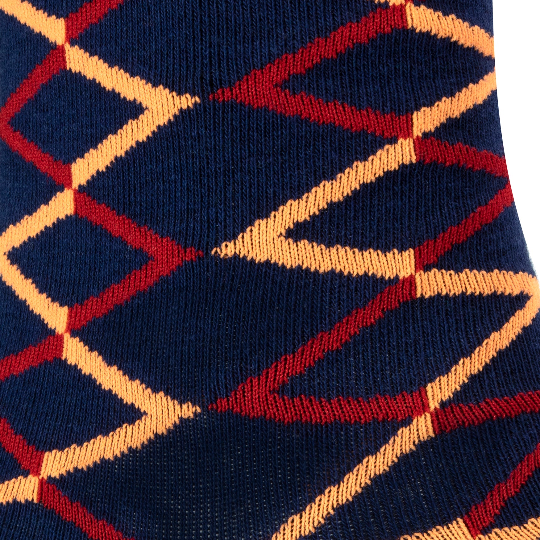 Textured view of a combed cotton dark navy seamless toe anklet with a red and orange diamond shape design.