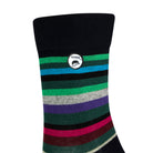 Side view of a combed cotton black seamless toe anklet with green, blue, black, grey, purple and pastel yellow stripes with a black heel and Dapper Chameleon logo.