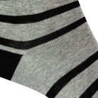 Textured heel view of a combed cotton grey seamless toe anklet with black stripes with a black heel.