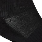 Textured view of a long length ribbed black combed cotton seamless toe anklet with cushioned foot and circular gripper around the arch of the foot.