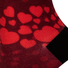 Textured heel view of a red seamless toe sock with red hearts print design and black heel.