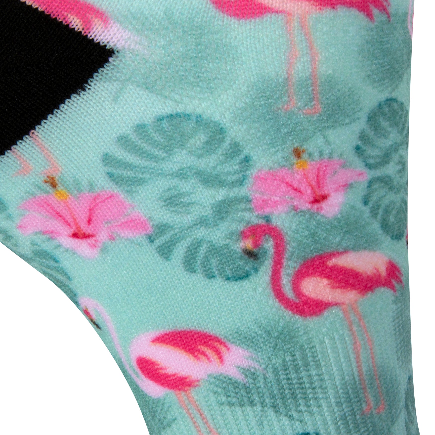 Textured heel view of a pastel mint green seamless toe sock with pink flamingo and green tropical leaves design print and black heel.