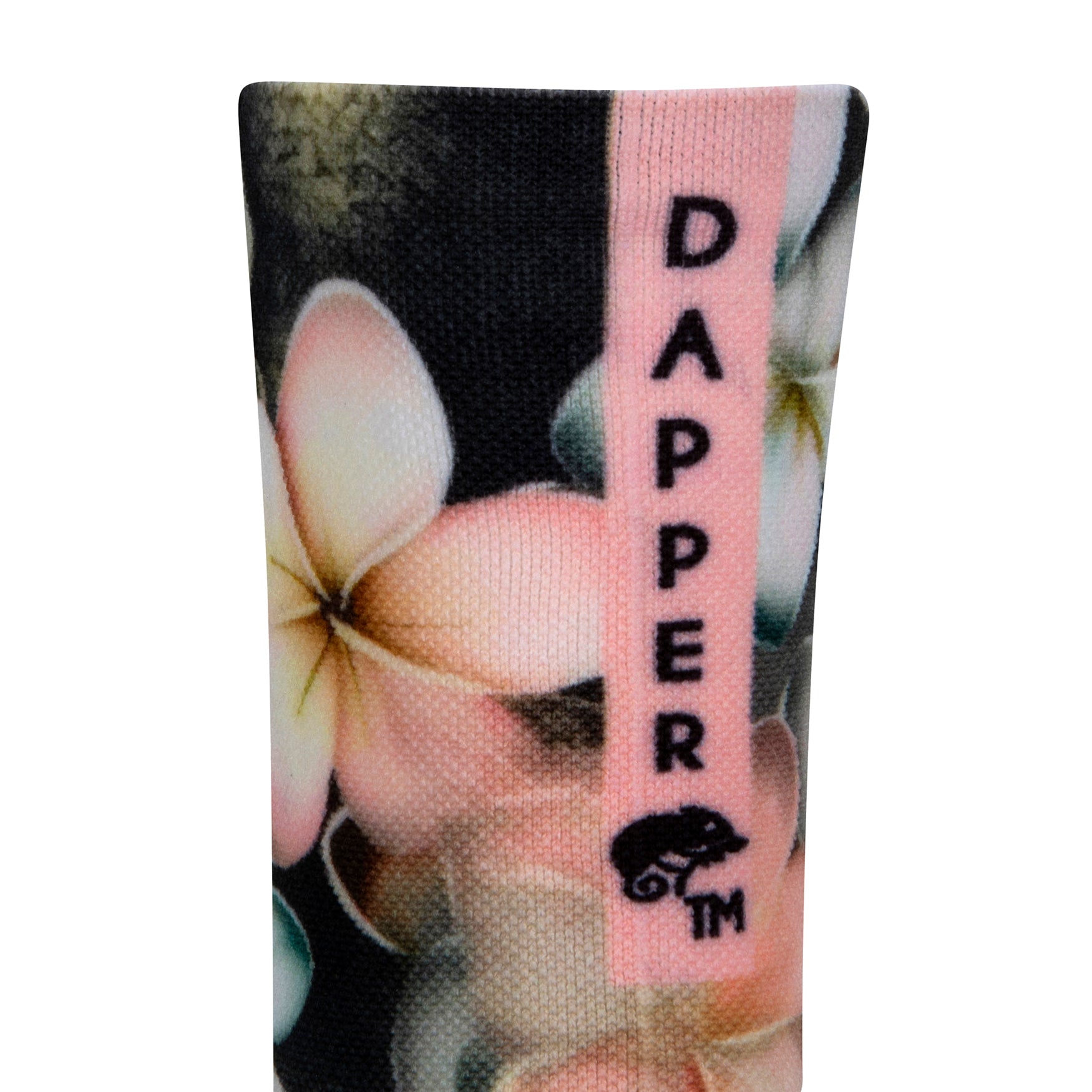 Back view of a dark grey seamless toe sock with pastel hues of white, cream, yellow, and light pink frangipani print design with a pastel pink strip with Dapper Chameleon wording and logo in black.