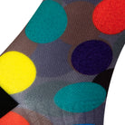 Textured heel view of a dark grey seamless toe sock with colourful red, orange, blue, green and yellow golf balls print design and black heel.