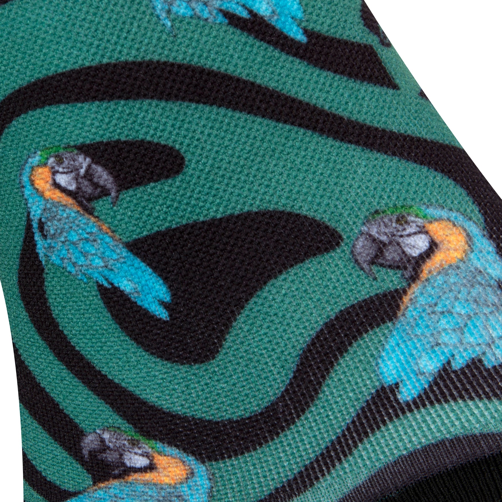 Textured view of a black seamless toe sock with emerald green swirls and blue and yellow parrot design print.